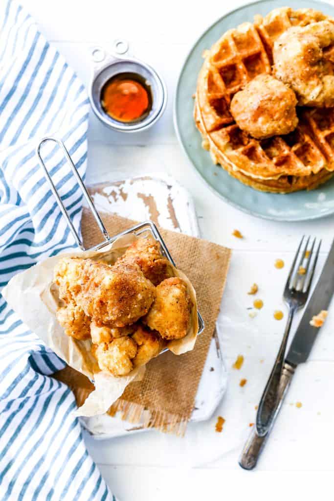 Chicken fried cauliflower in a basket and Belgian waffles.