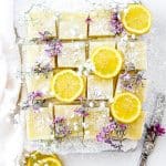 Vegan Lemon Drop Bars next to a knife and a linen.