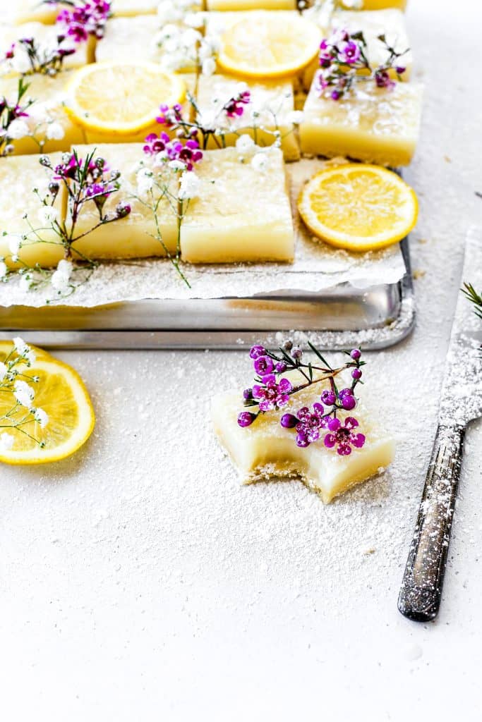 Vegan lemon drop bar with a bite taken out of it.