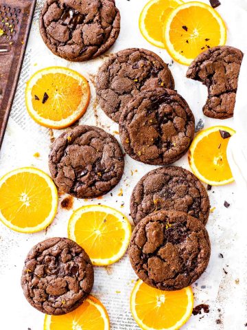 Vegan orange chocolate cookies and orange slices.