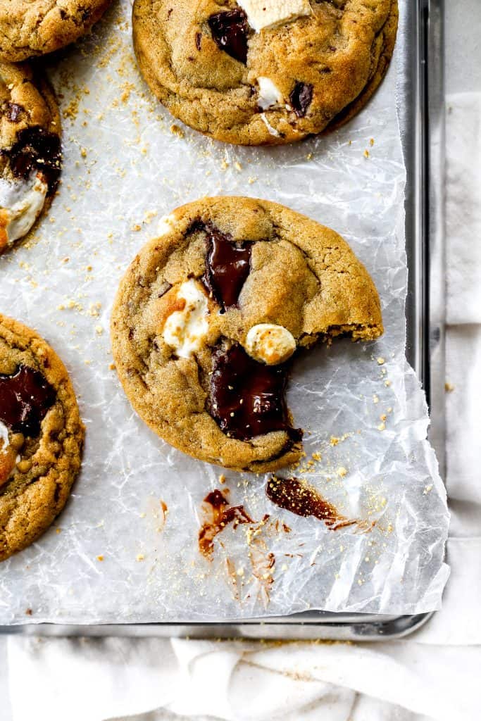 Vegan S'mores Cookie with a bite taken out of it on a baking sheet.