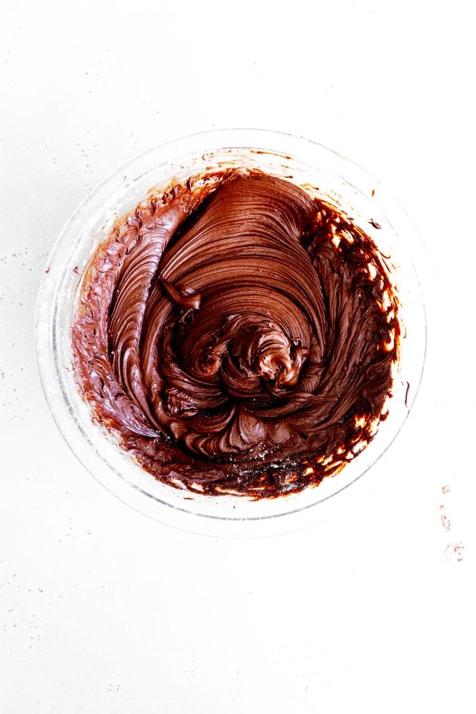 Glass bowl filled with melted chocolate.