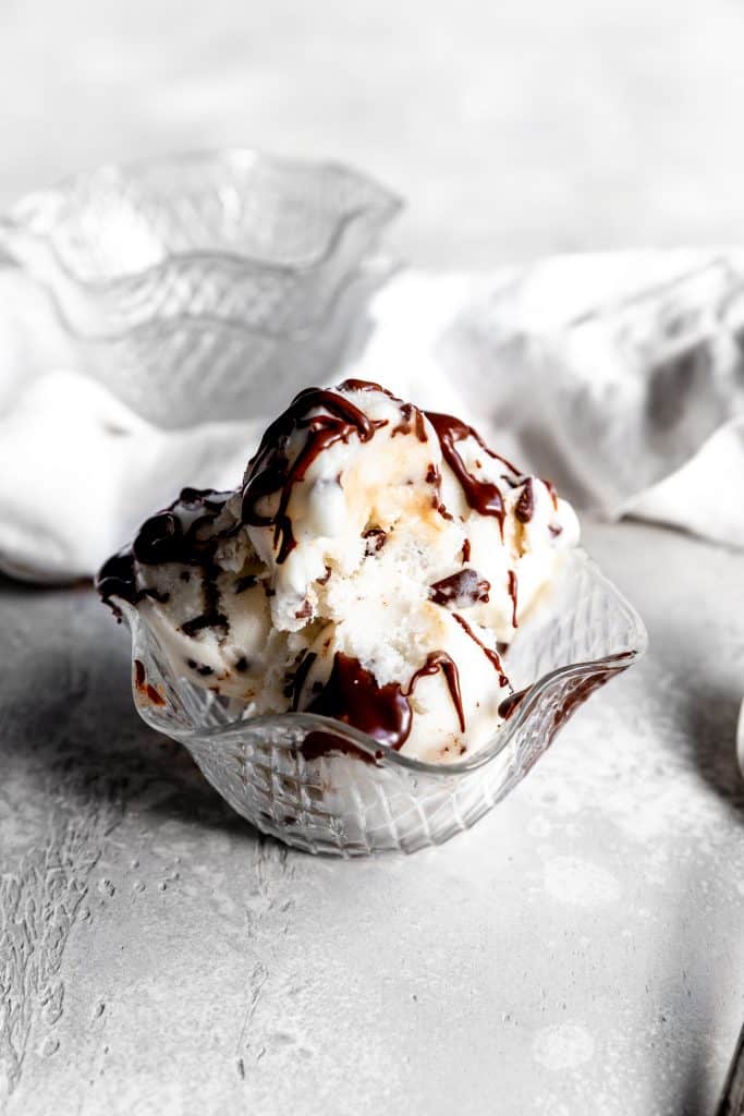 Partially eaten bowl of vegan mint chip ice cream.