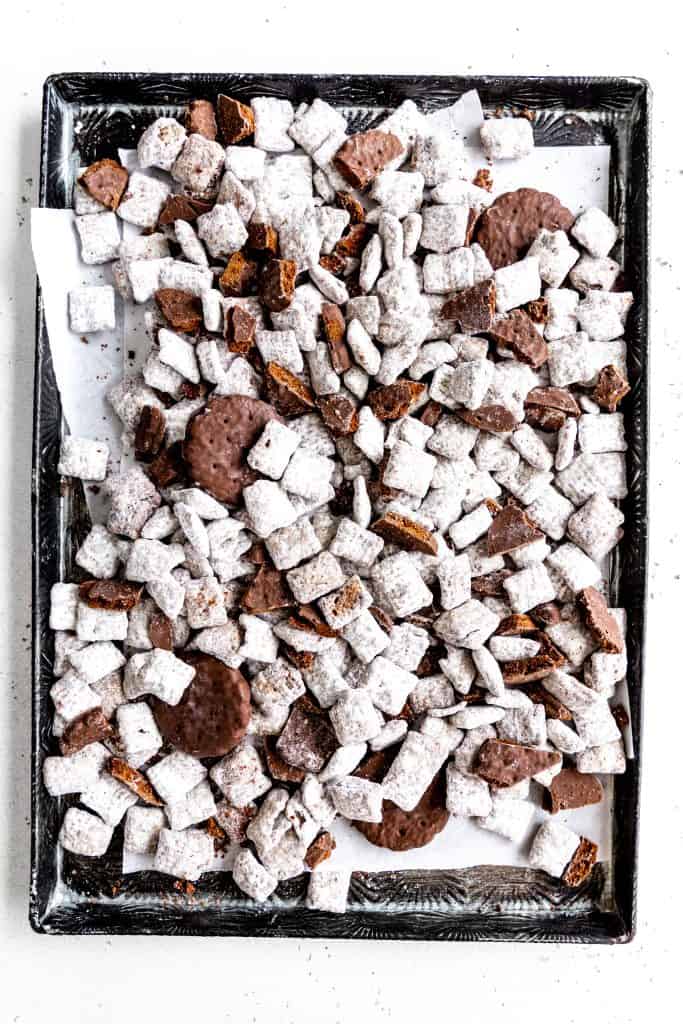 Thin mint muddy buddies on a baking sheet lined with parchment paper.