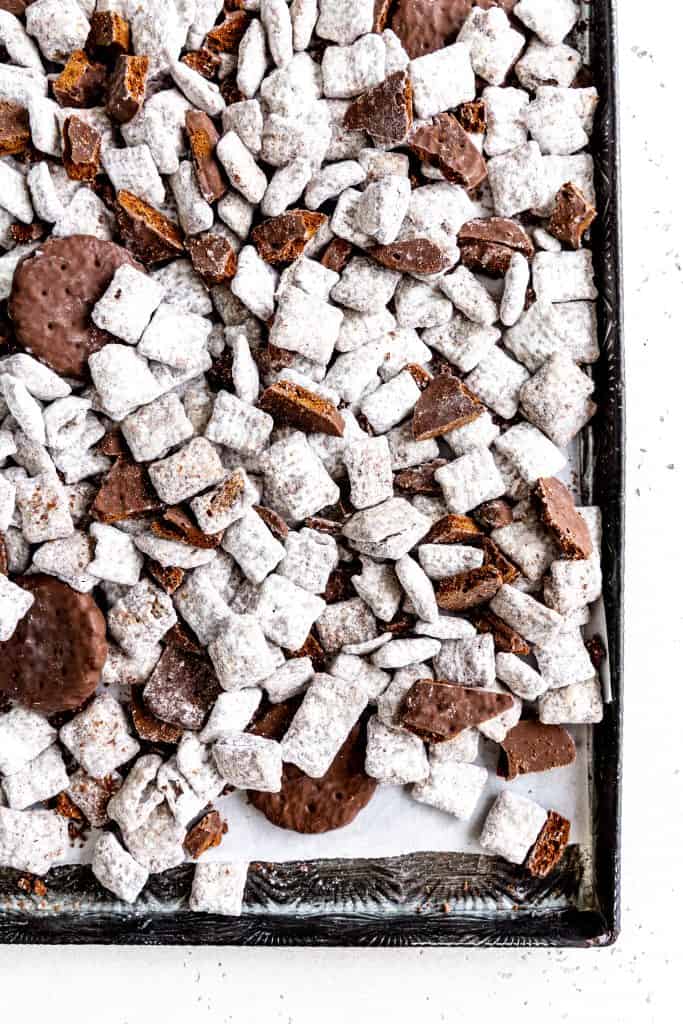 Thin mint muddy buddies on a baking sheet lined with parchment paper.