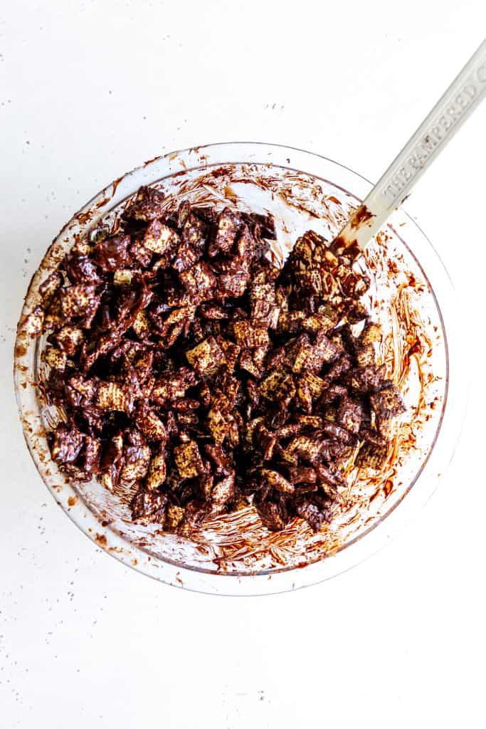 Glass bowl filled with Rice Chex cereal coated in chocolate.