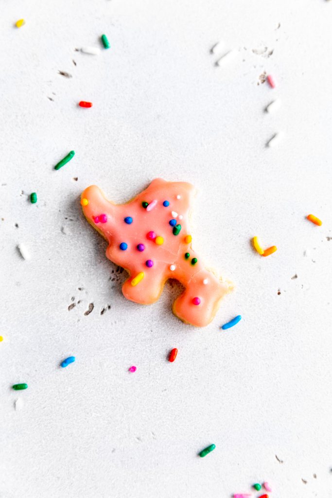 Pink, elephant-shaped vegan animal cookie with a bite taken out of it.