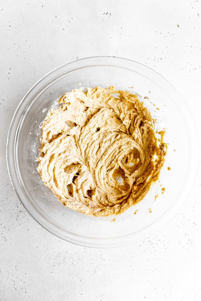 Creamed butter and sugar in a glass bowl.