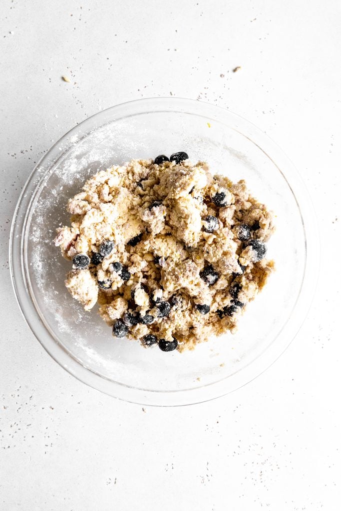 Lemon blueberry scone dough in a glass bowl.