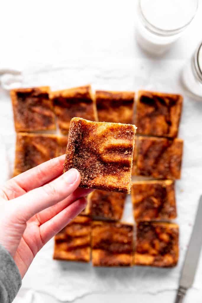 Hand holding a snickerdoodle bar.