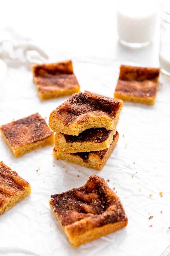 Stack of snickerdoodle bars and a glass of milk.