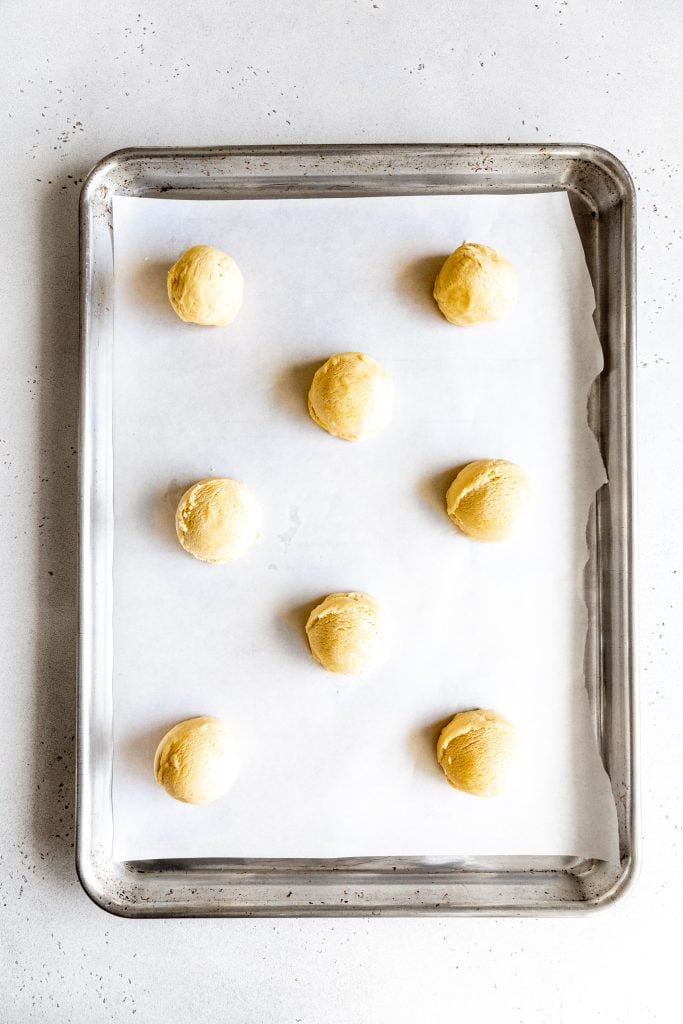 Unbaked sugar cookies on a baking sheet.