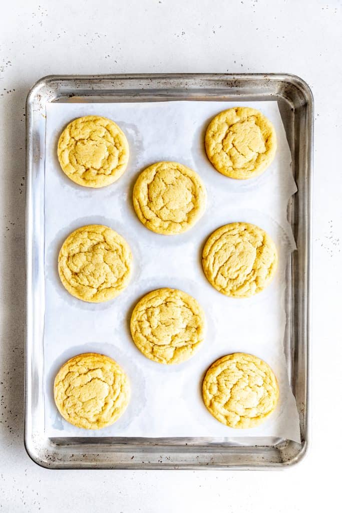 Baked sugar cookies on a baking sheet.