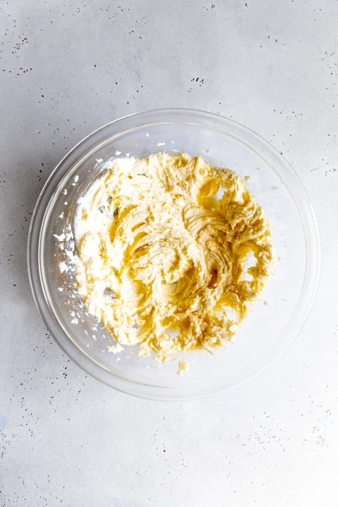 Creamed butter and sugar in a glass bowl.