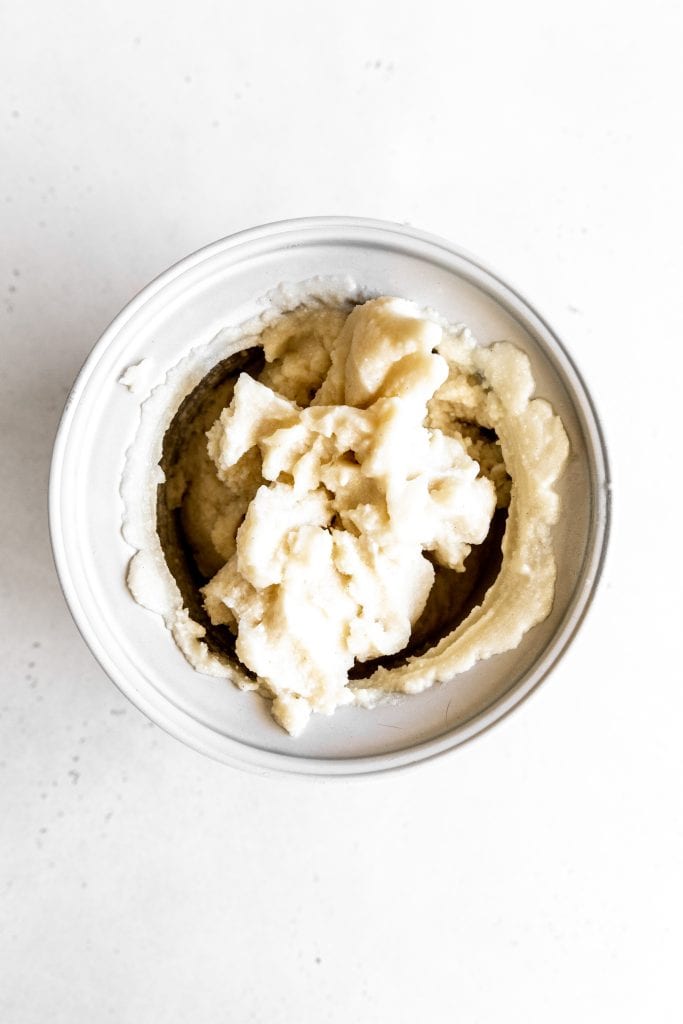 Churned vanilla ice cream in an ice cream maker.