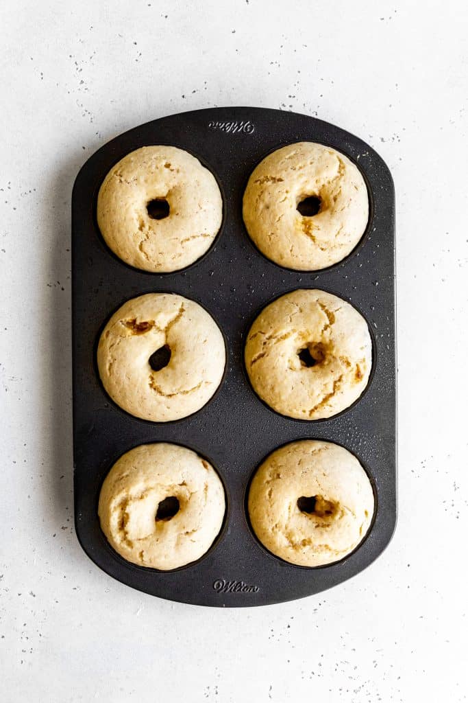 Baked vegan donuts in a baking pan.