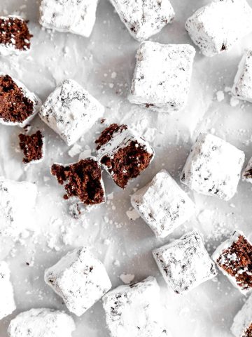 Brownie bite broken in half on a baking sheet with more brownie bites.