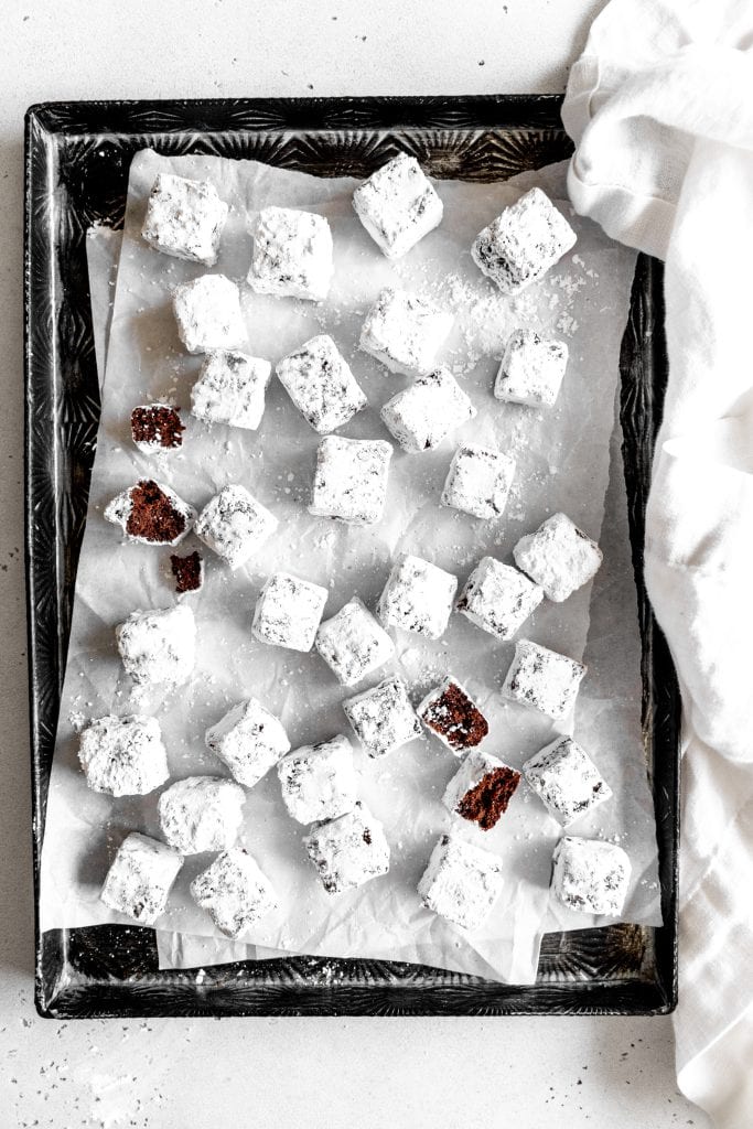 Brownie bites scattered on a baking sheet.