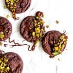 Double chocolate cookies drizzled in melted chocolate and topped with chopped pistachios.