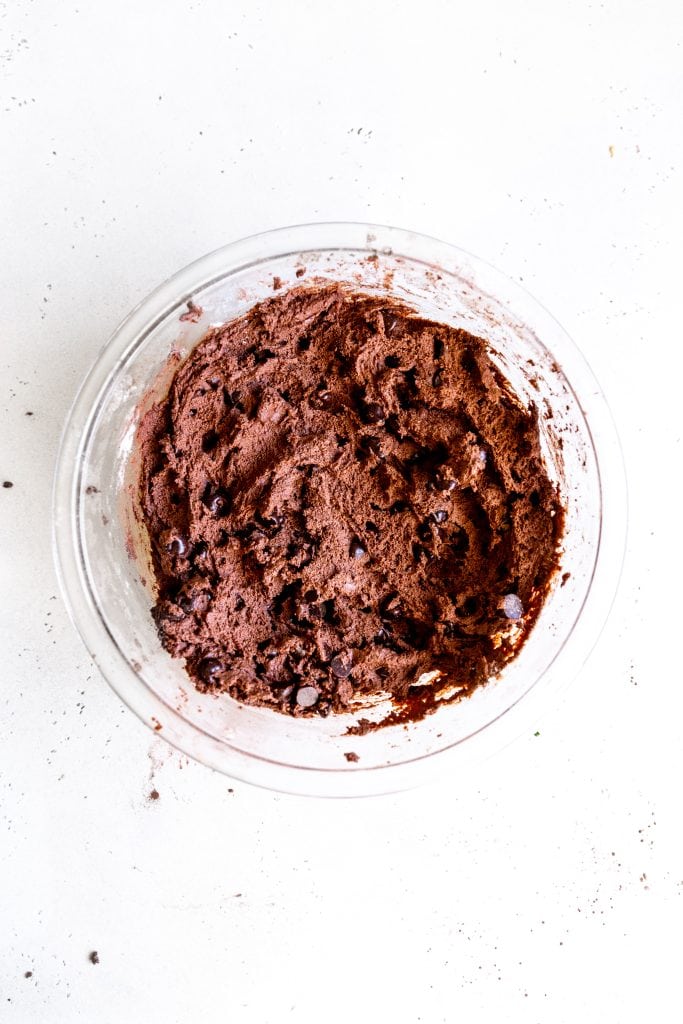 Glass bowl filled with chocolate cookie dough.