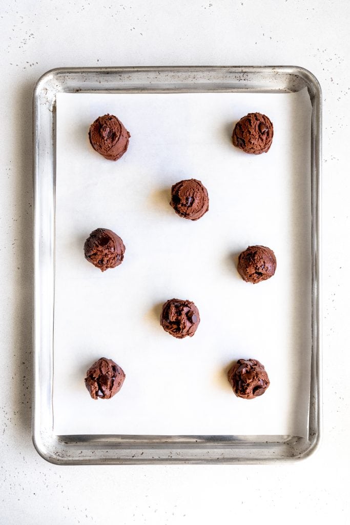 Unbaked double chocolate cookies on a baking sheet.