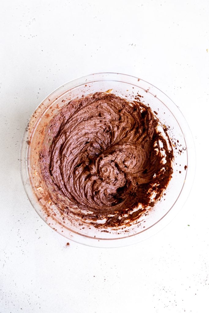 Glass bowl filled with creamed butter, sugar and cocoa.