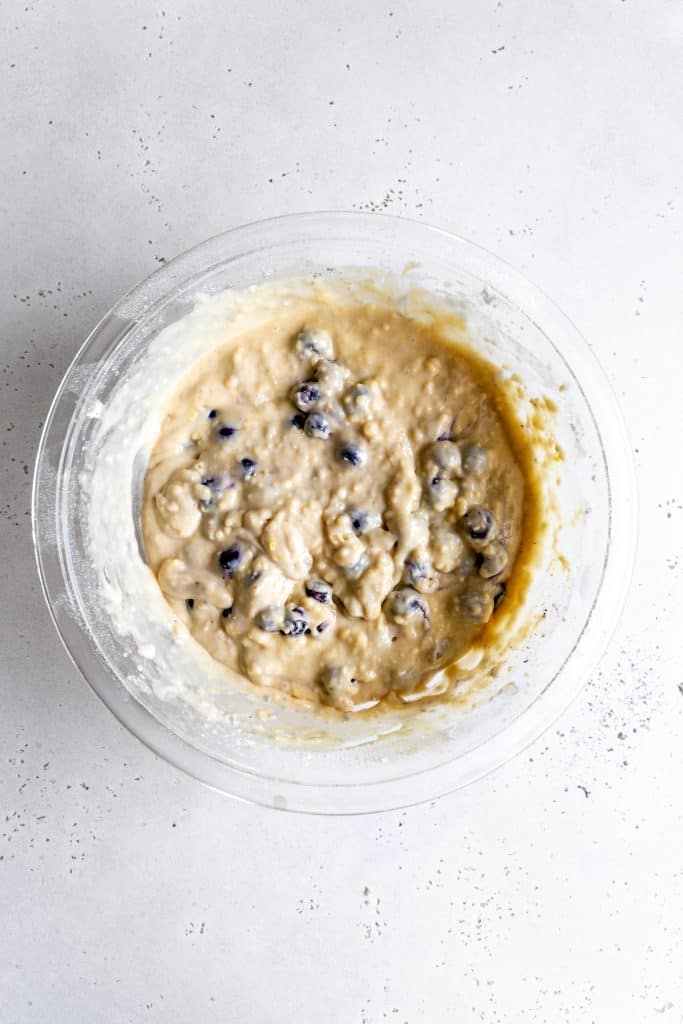 Glass bowl filled with lemon blueberry muffin batter.