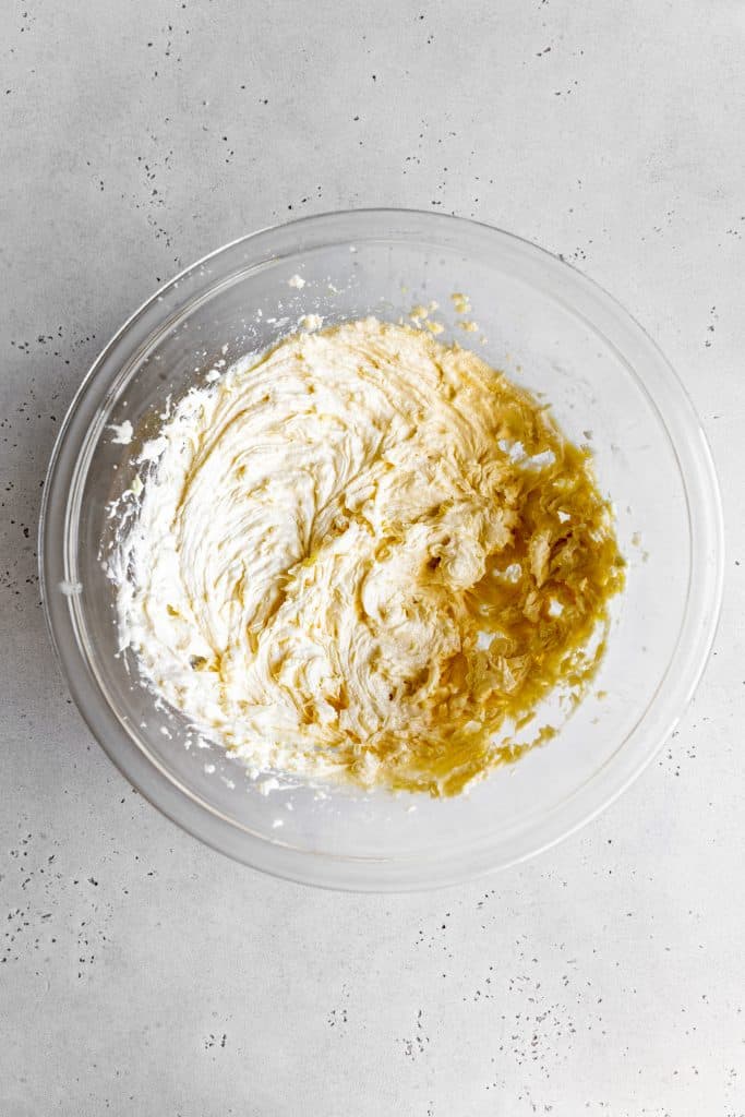 Creamed butter and sugar in a glass bowl.