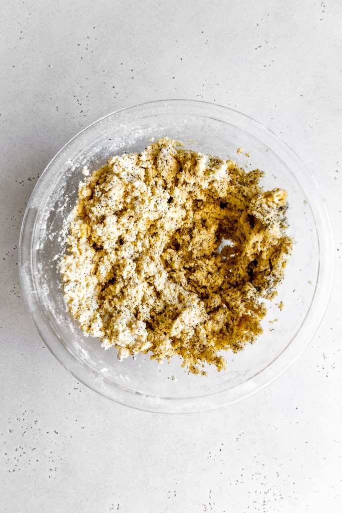 Lemon poppy seed cookie dough in a glass bowl.