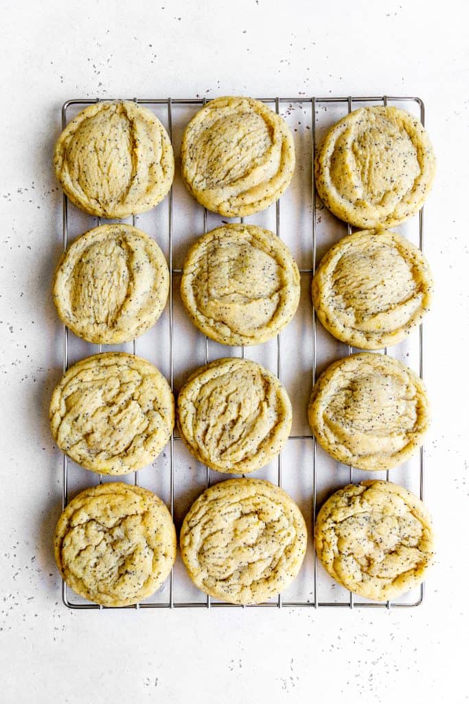 Lemon poppy seed cookies on a wire cooling rack.