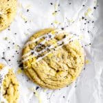 Lemon poppy seed cookie drizzled in glaze on parchment paper.