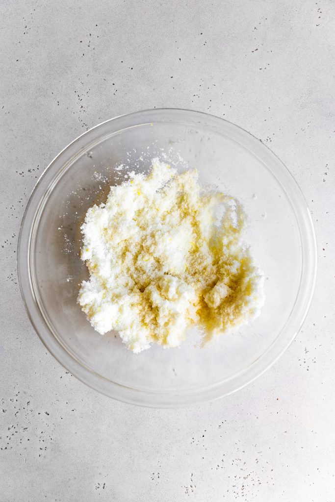 Glass bowl of granulated sugar and lemon zest.