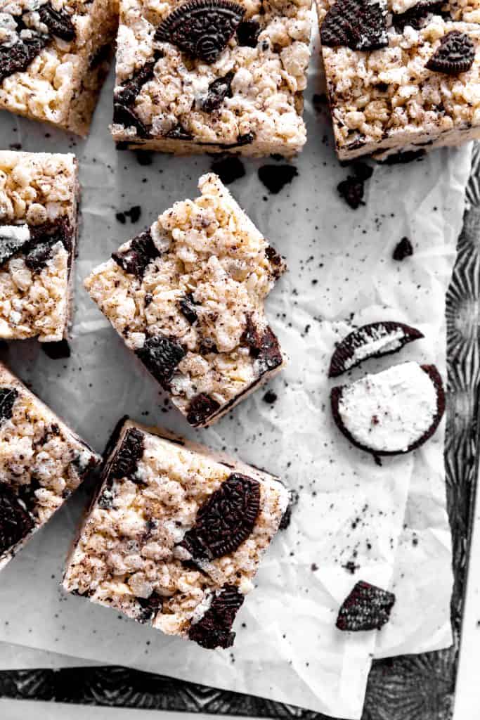 Oreo rice krispie treat with a bite taken out of it on a baking sheet with more treats.