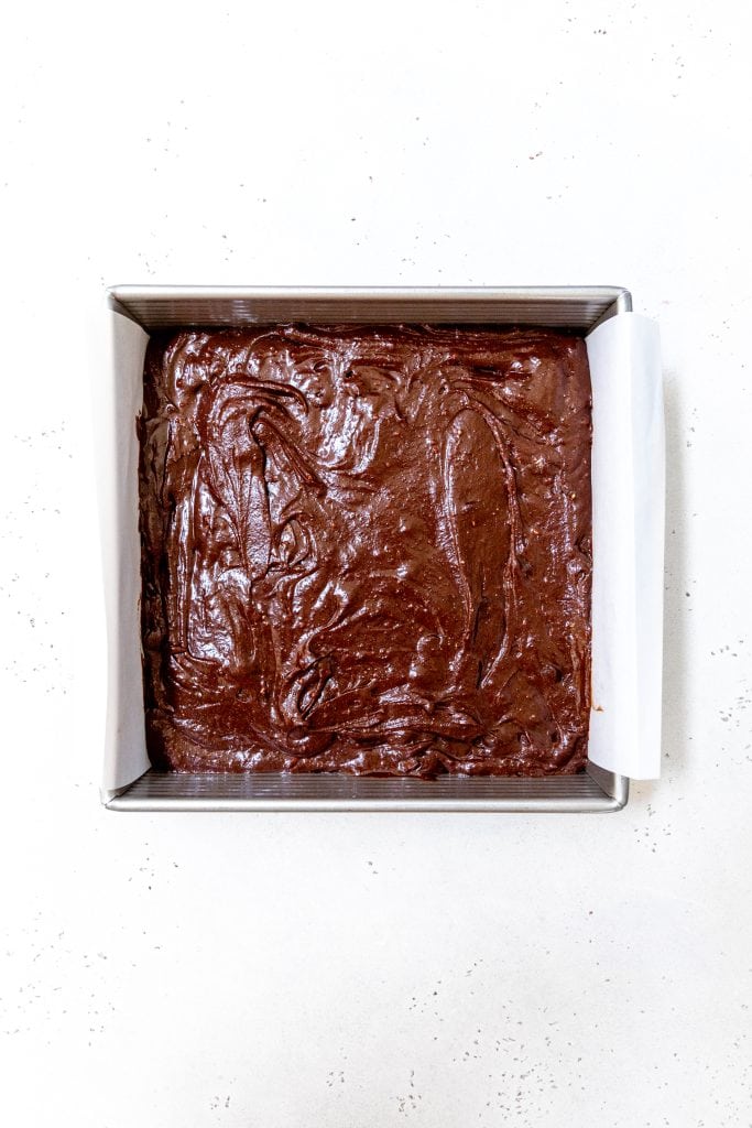 Square pan of unbaked vegan brownies.