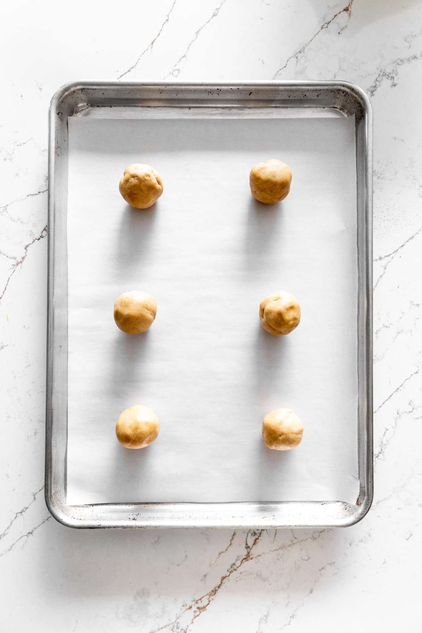 Unbaked apple cider cookies on a baking sheet.