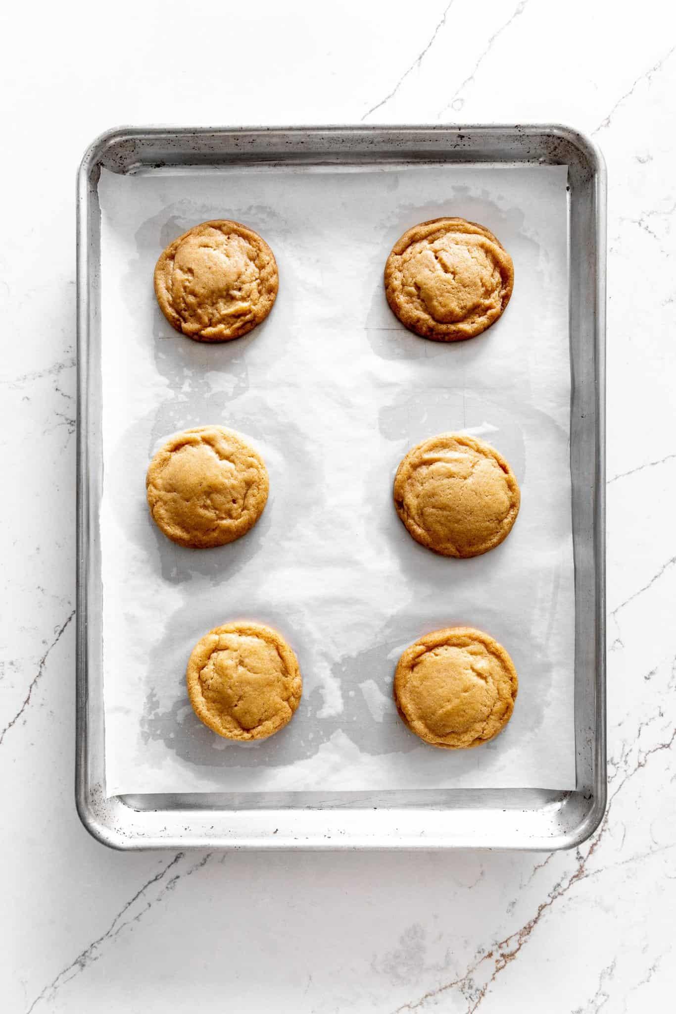 Baked apple cider cookies on a baking sheet.