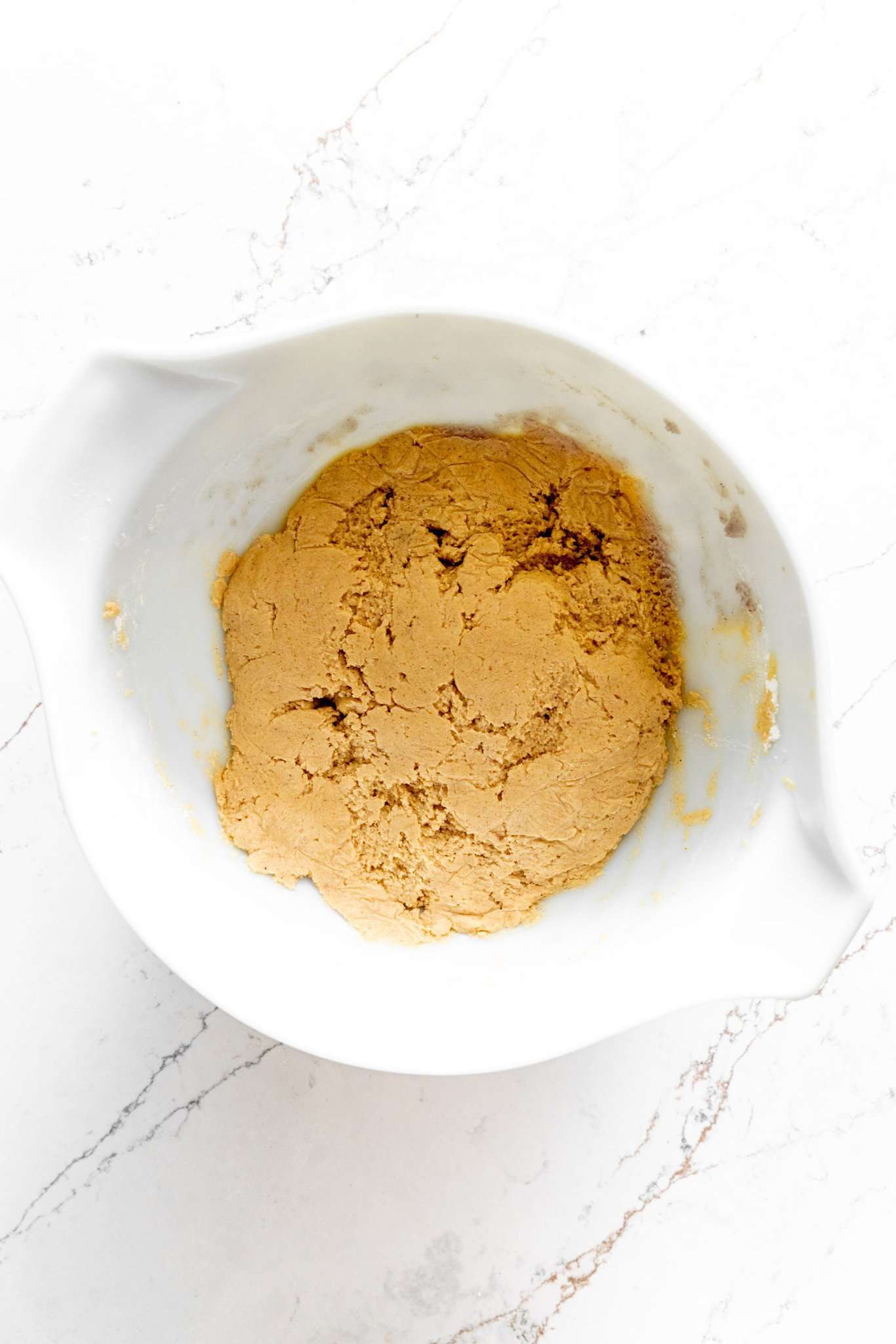 White bowl filled with apple cider cookie dough.