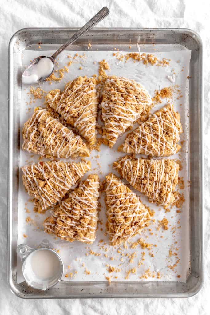 Apple cinnamon scones arranged in a circle on a baking sheet.