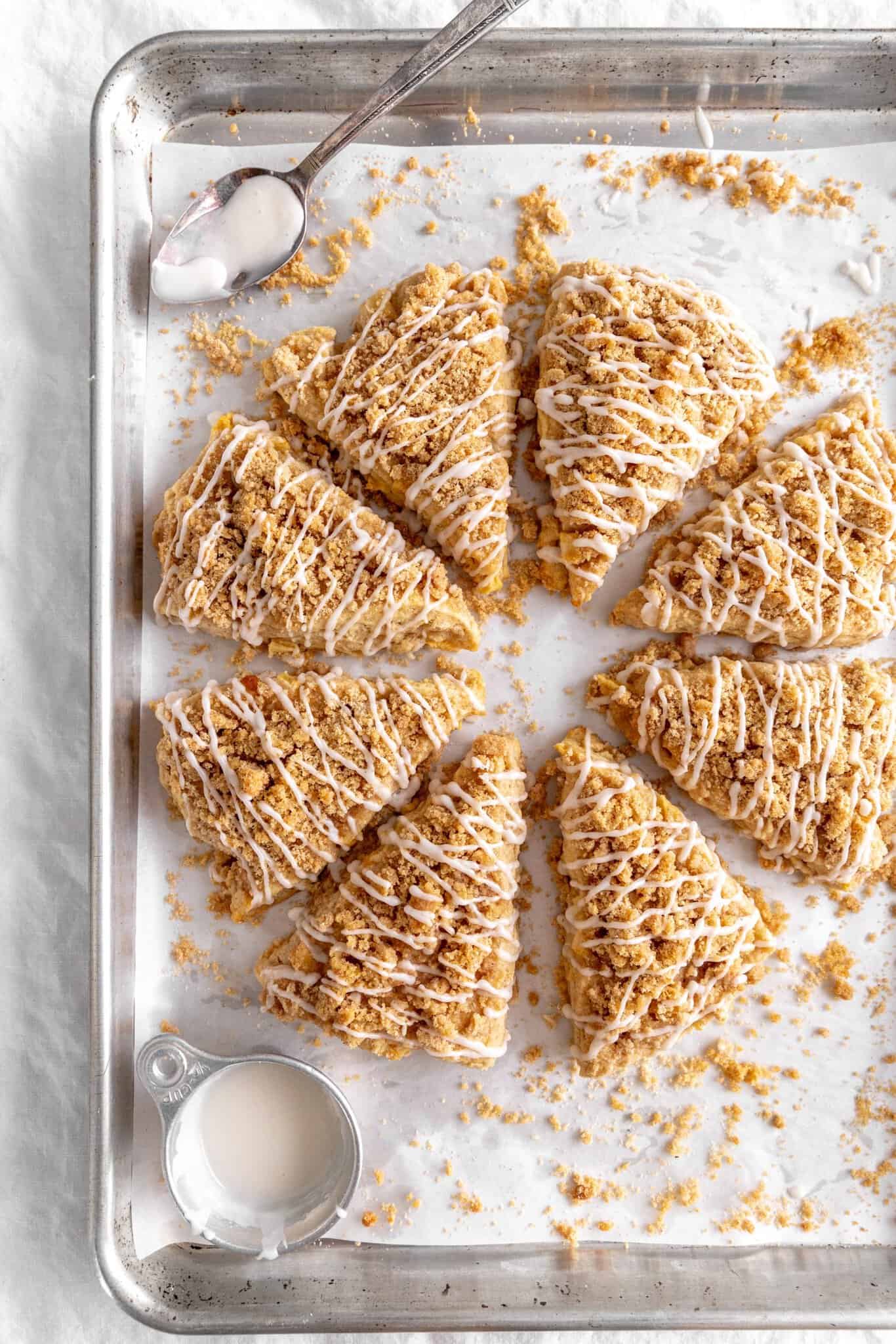 Apple cinnamon scones arranged in a circle on a baking sheet.