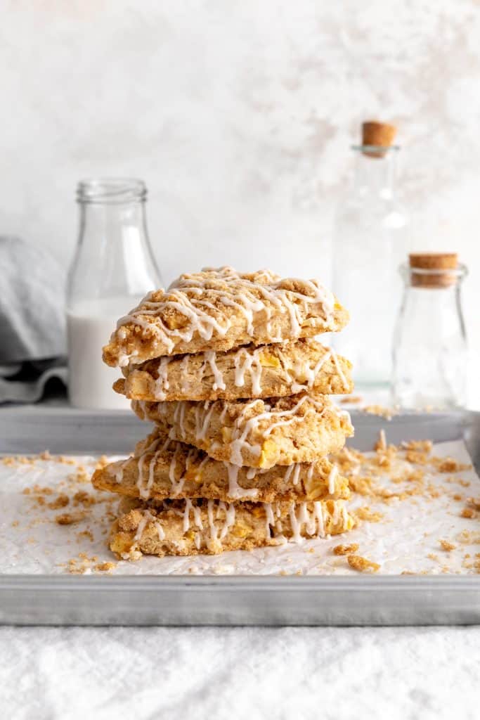 Stack of apple cinnamon scones on a baking sheet.