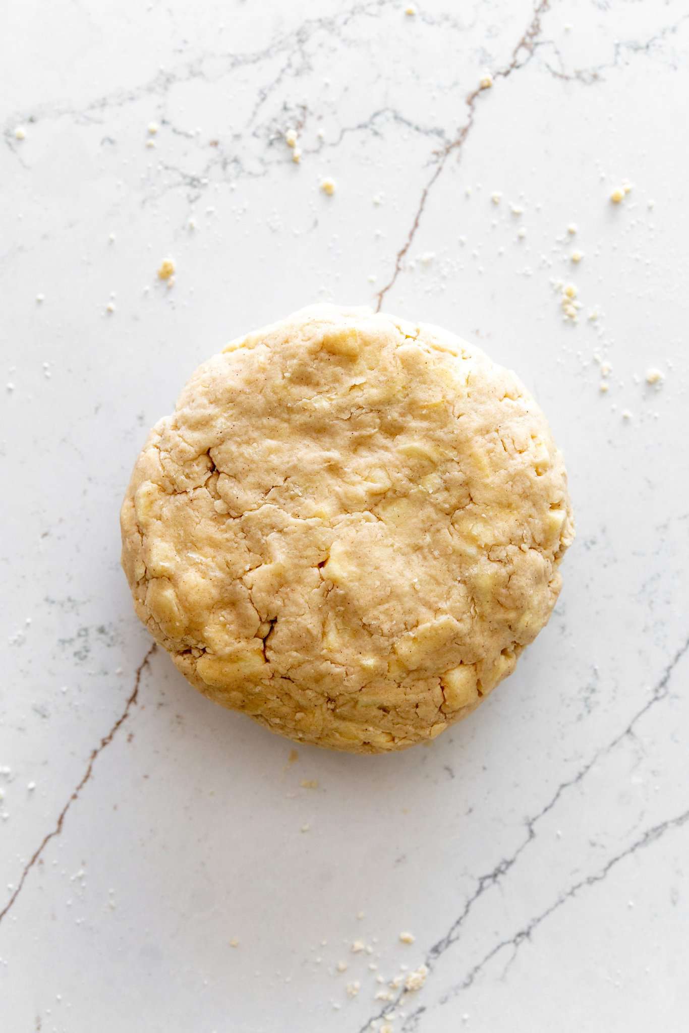 Scone dough shaped in a disk on the countertop.