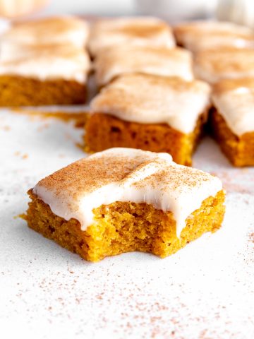 Vegan pumpkin bar with a bite taken out of it.