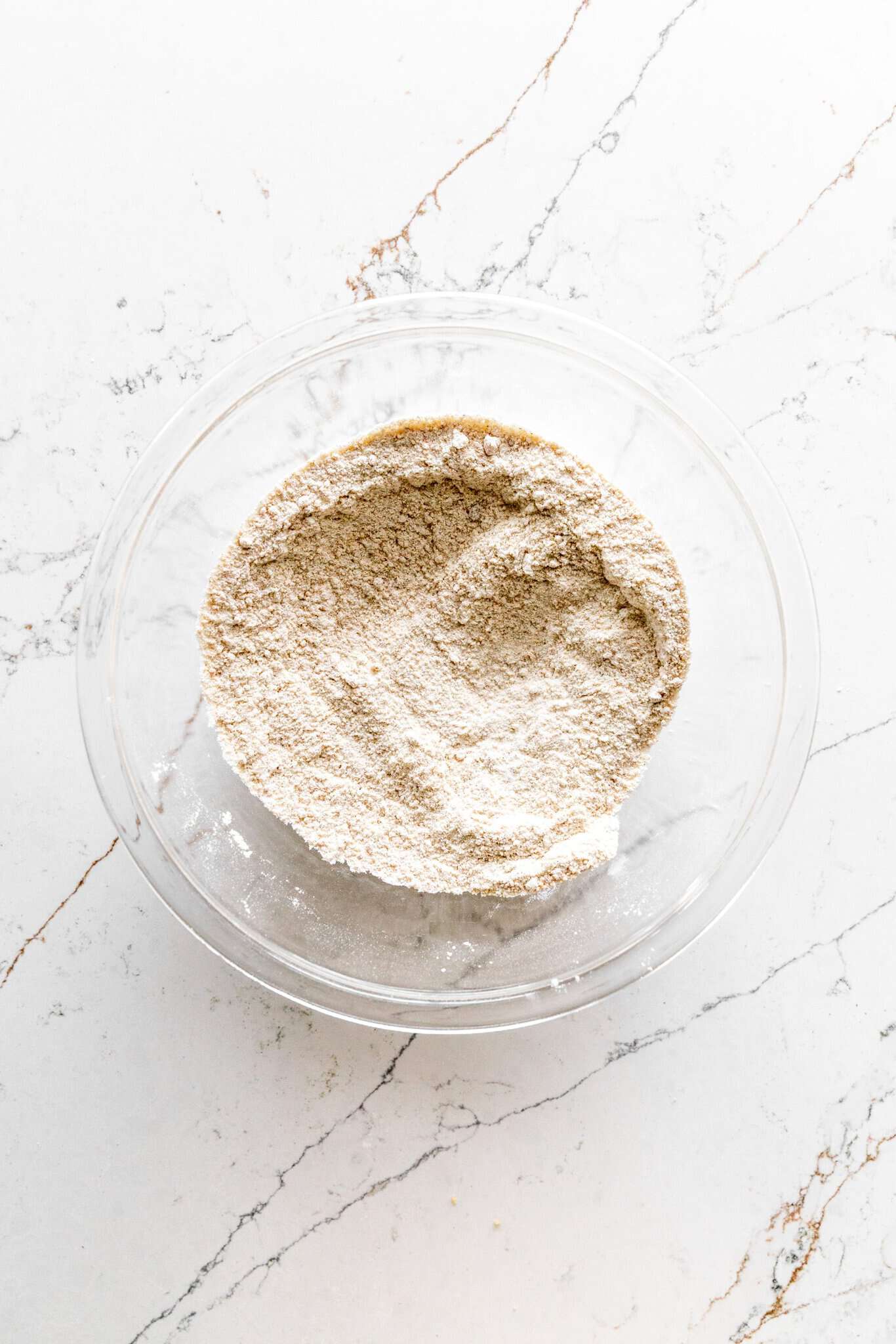 Glass bowl of mixed flour, sugar and spices.