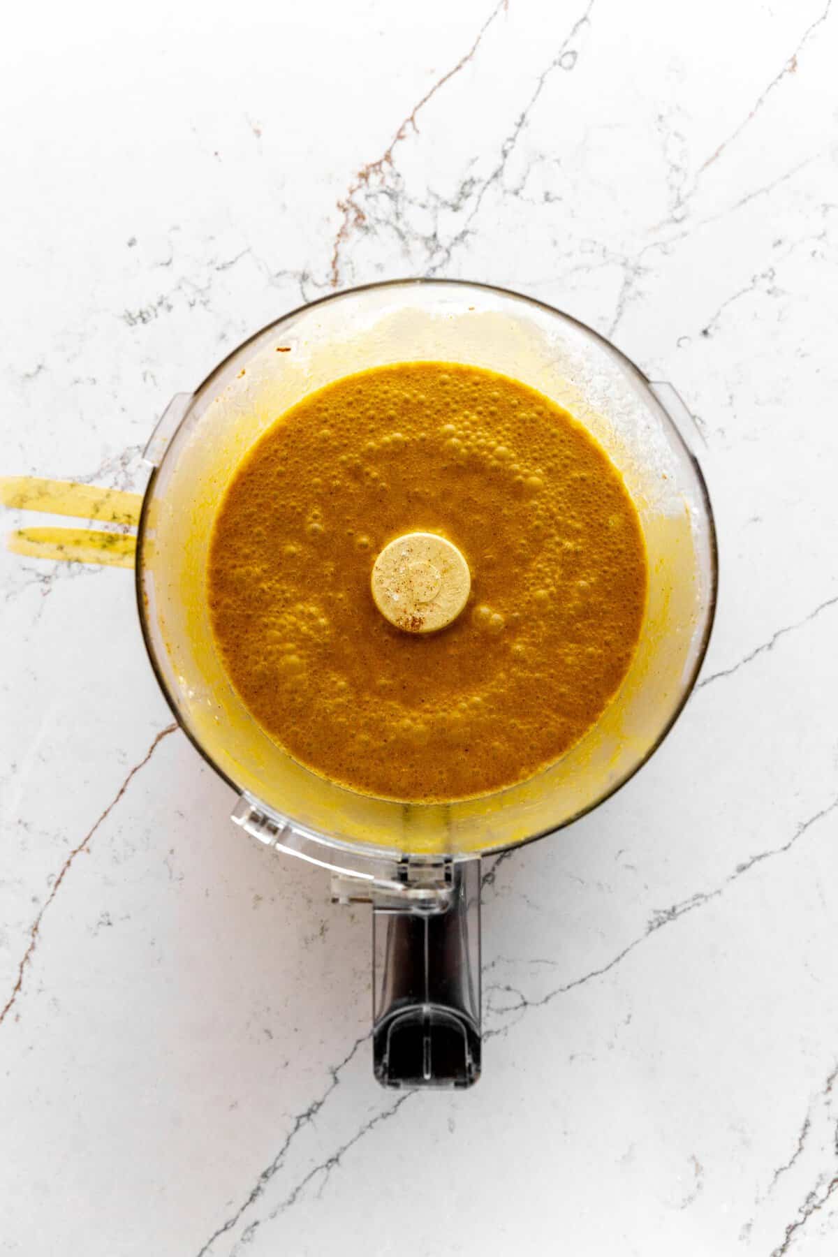 Pumpkin pie filling in a food processor.