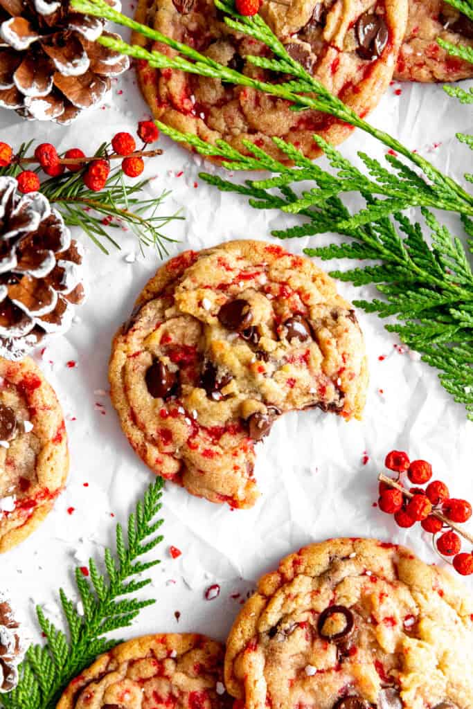 Candy cane chocolate chip cookie with a bite taken out of it.