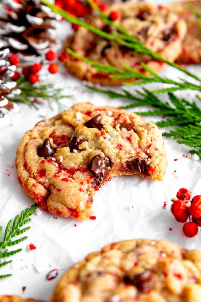 Candy cane chocolate chip cookie with a bite taken out of it.