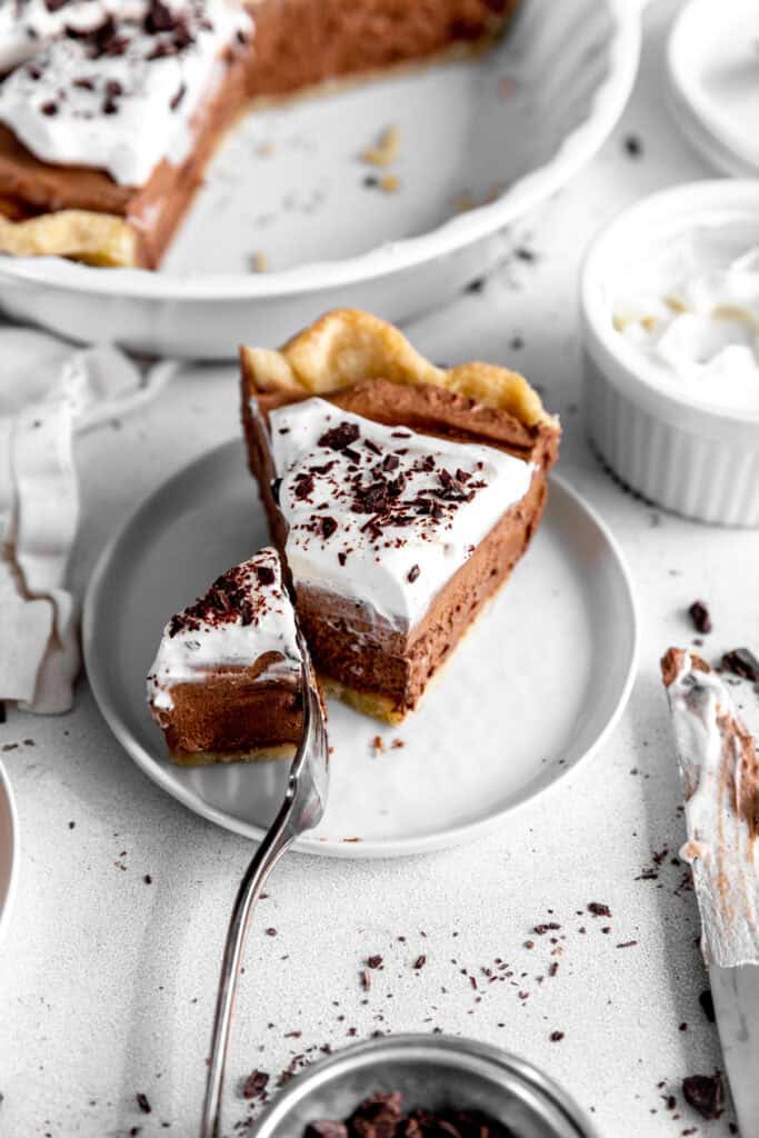 Fork cutting into a slice of chocolate fudge pie.