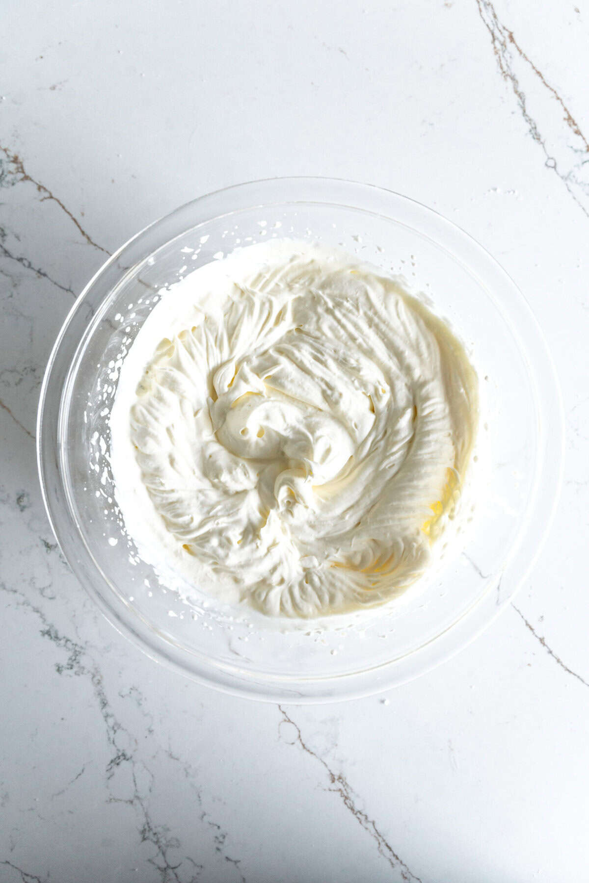 Glass bowl of homemade whipped cream.