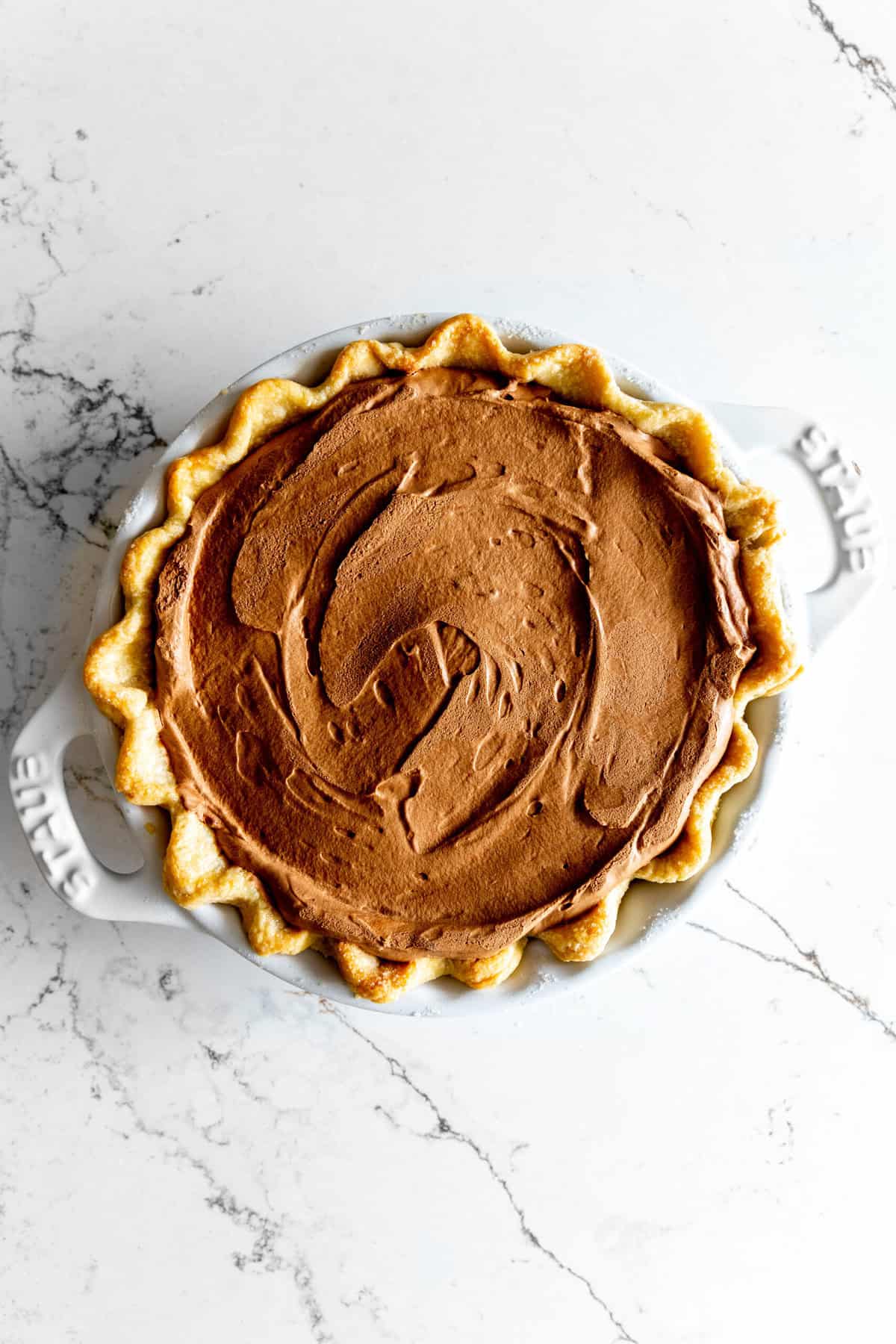 Chocolate pie in a white dish.