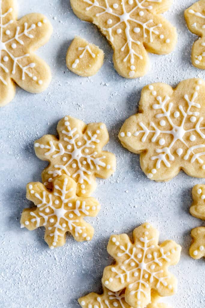 Frosted snowflake sugar cookies on a light blue background.